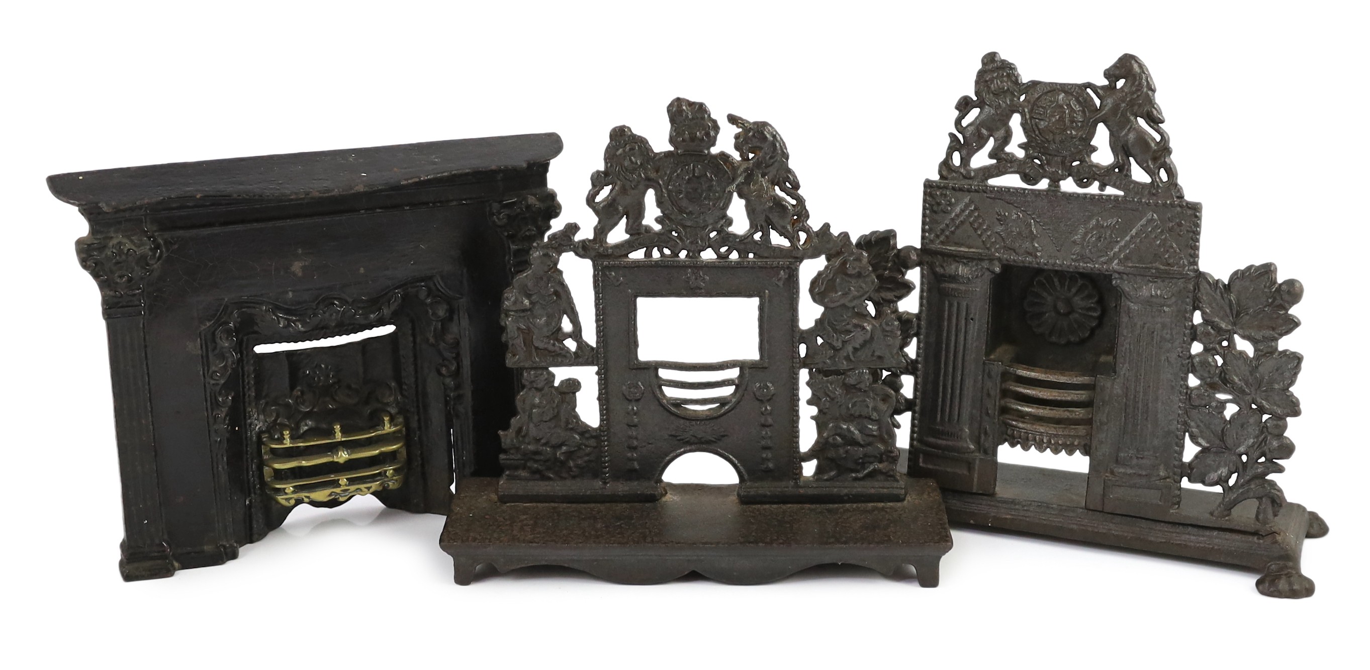 Three early 19th century cast iron model fire grates, two incorporating Royal Arms, largest 12in. wide